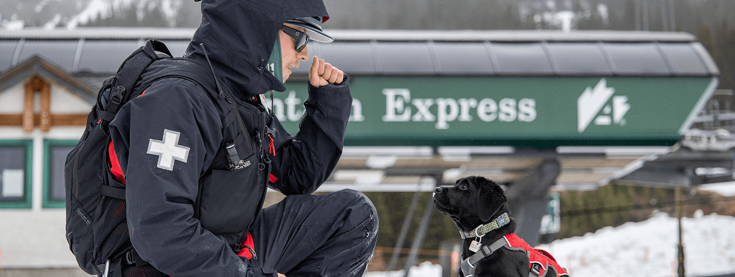 Ski Patroller with a dog at Arapahoe Basin