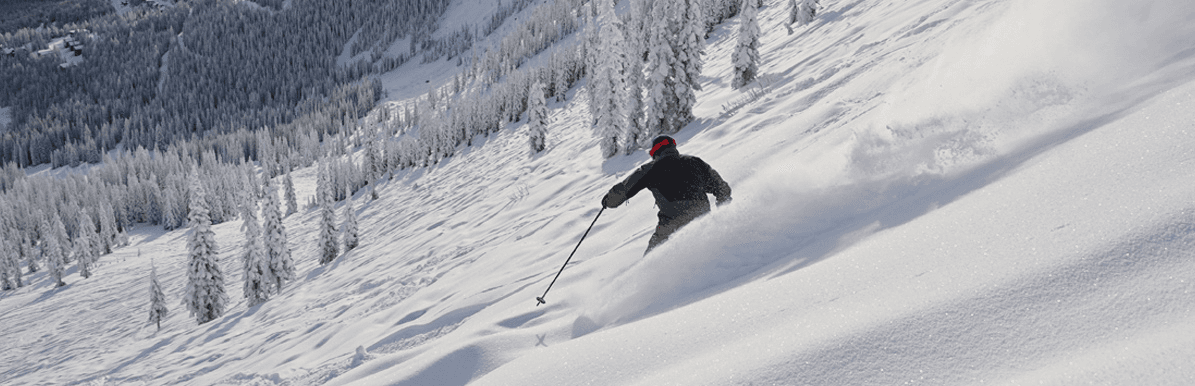 Skier enjoying a pwoder run at Schweitzer Mountain Resort